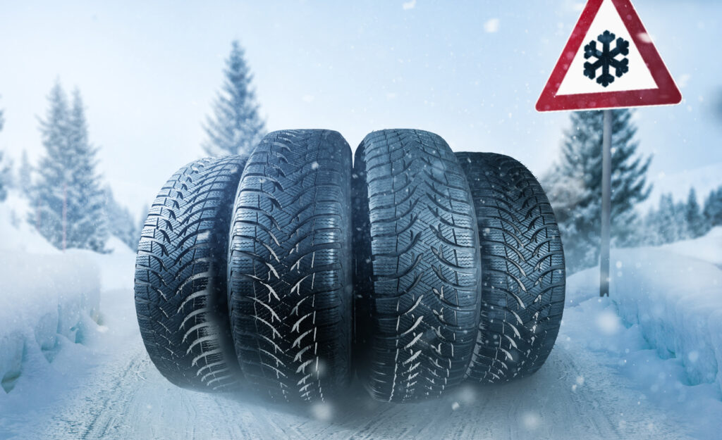 Car tires on a snow covered roadway