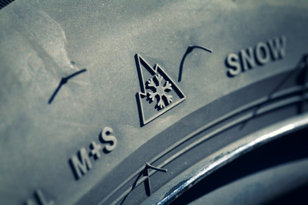 Winter tire sign M+S, selective focus, narrow depth of field