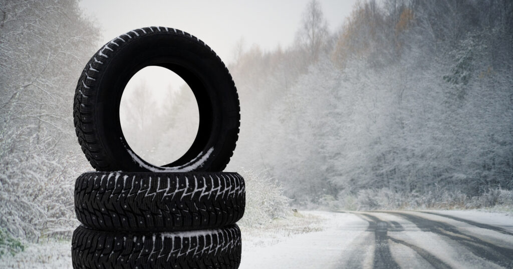 Winter tires on a snowy road. Seasonal tire change.