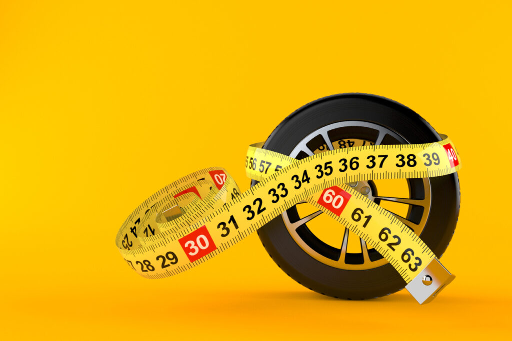 Car wheel with centimeter isolated on orange background. 3d illustration