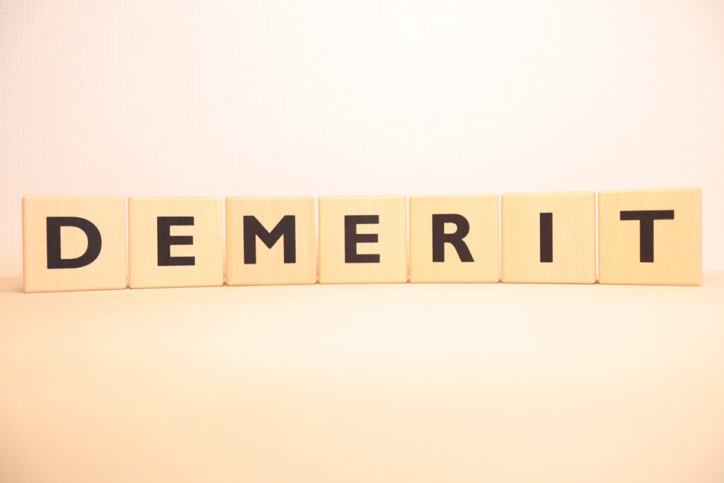 This is a wooden block of the alphabet letters of "DEMERIT".