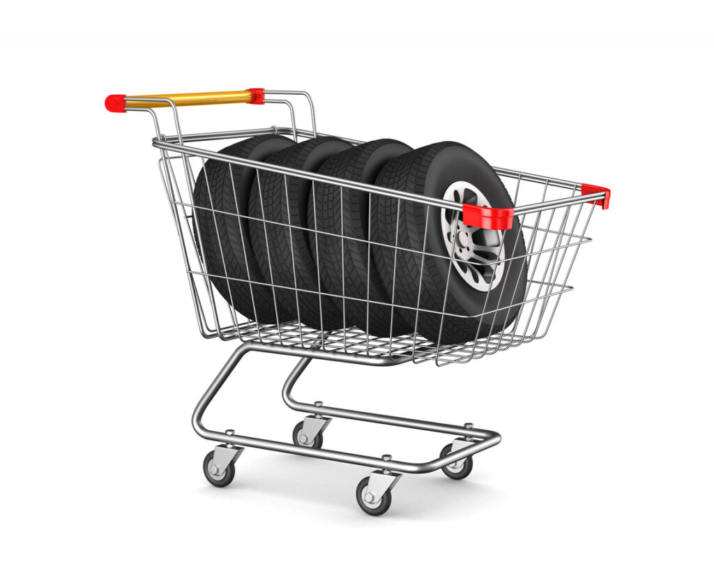 shopping cart and tyres on white background. Isolated 3D illustration