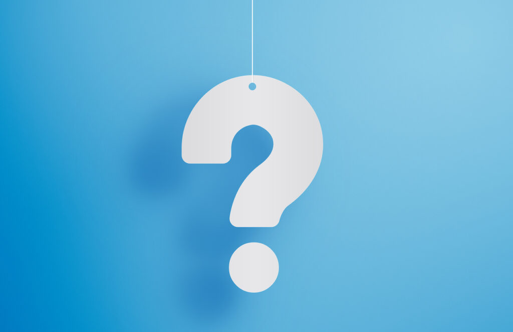 Hanging question mark on blue background stock photo