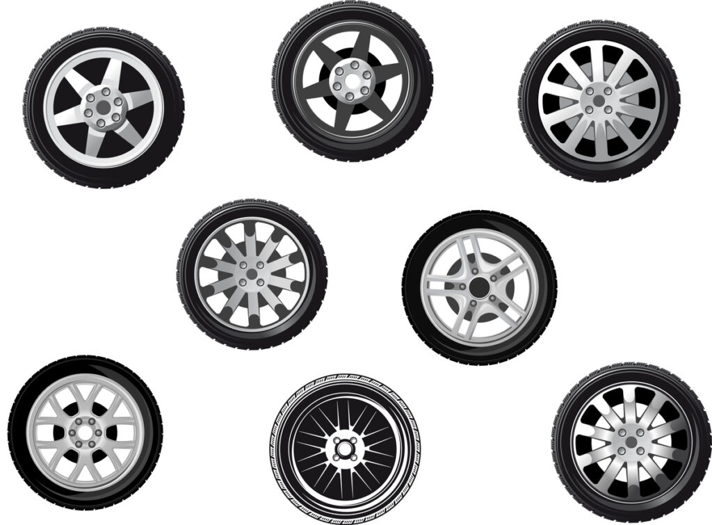 Collection of wheels or tyres with spoked alloy rims and hubs, isolated on white