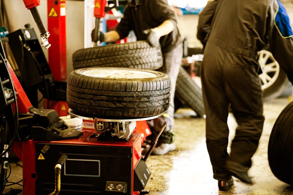 Auto mechanic changing tire.