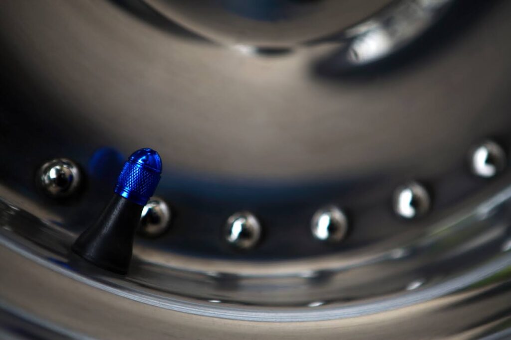 Blue Tyre Valve Cap on a Chrome Wheel
